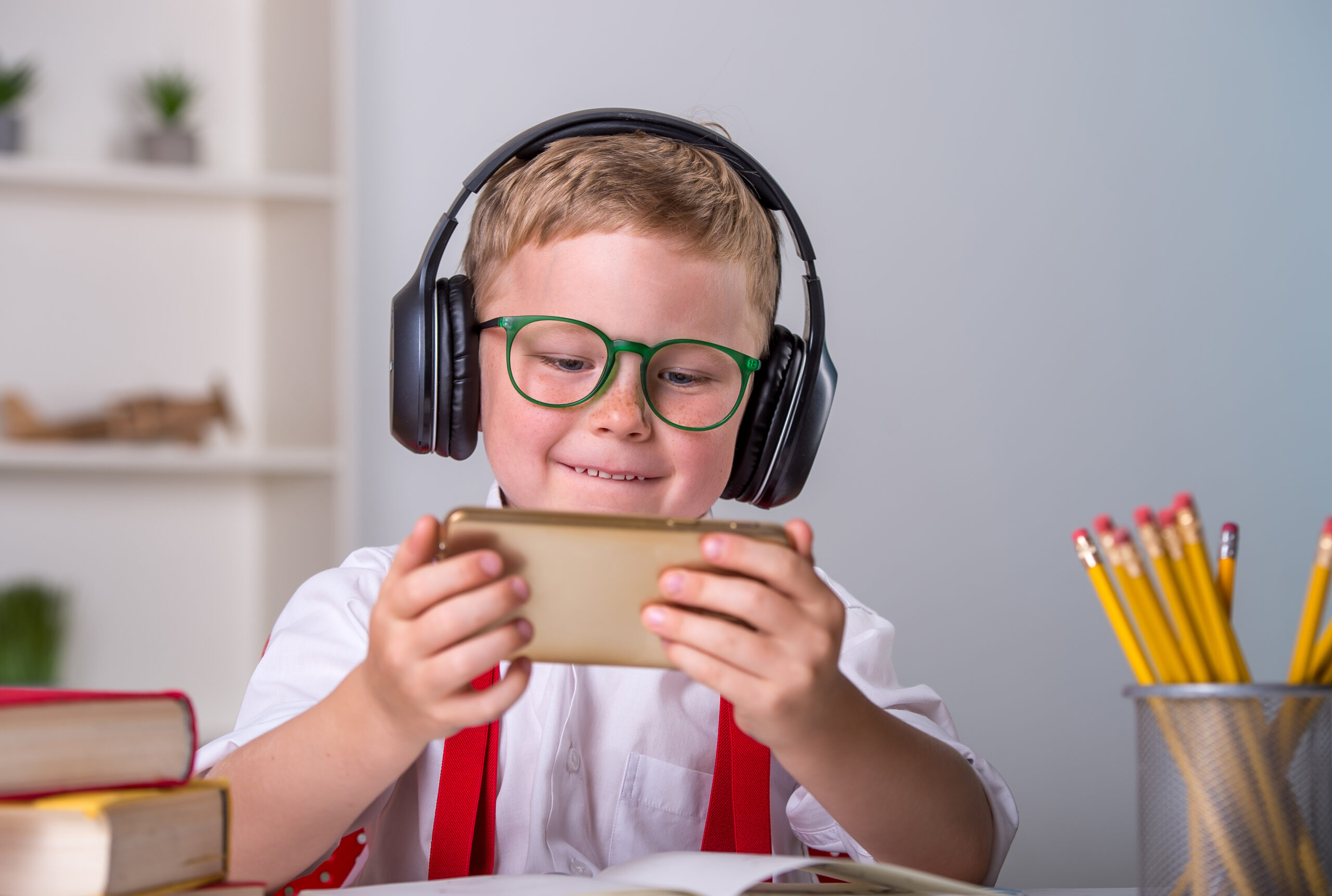 Funny,Little,School,Boy,In,Headphones,And,Using,Smartphone.,Child